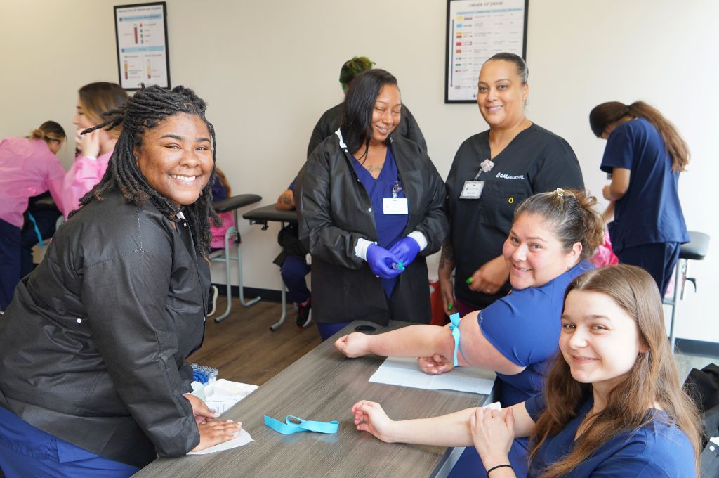 Students in Monterey phlebotomy classes practicing blood draws with CALRegional-administered training.